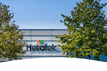 Photo of the Heliatek building facade with trees